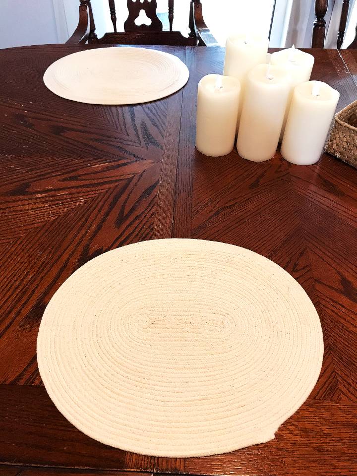 Cotton rope placemats arranged on a wood table.